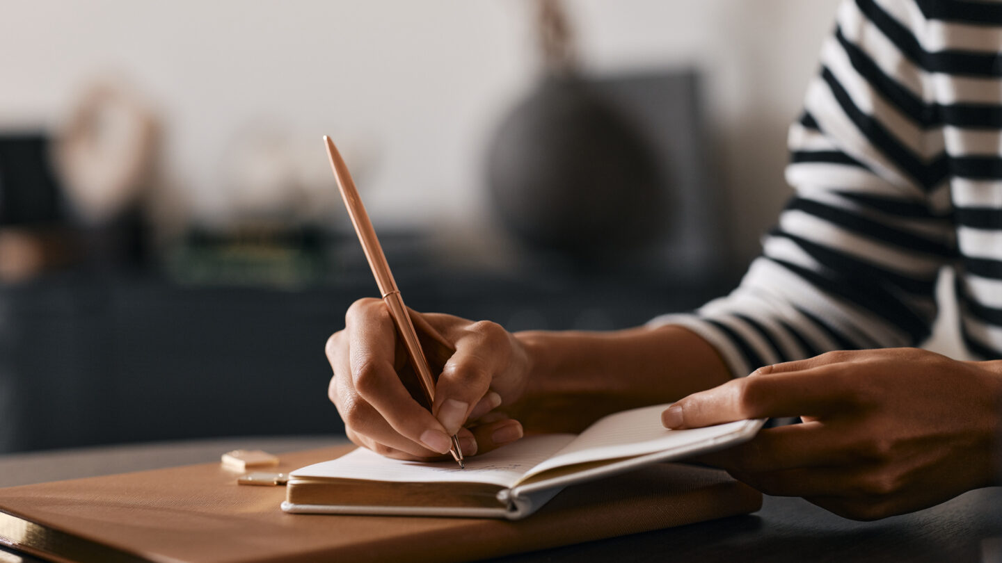Person writes in notebook at Orchard Place
