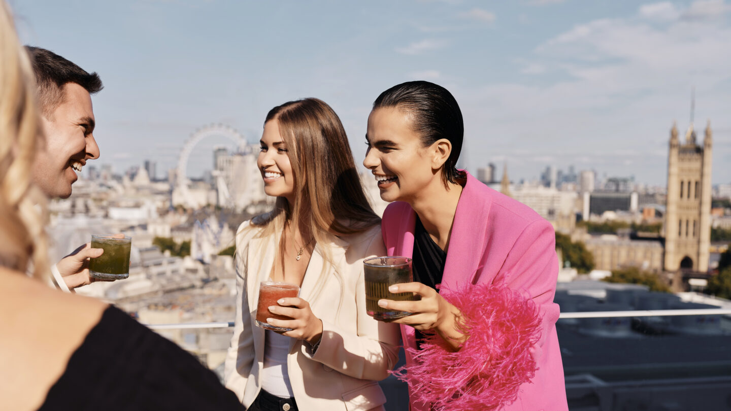 People having drinks looking out over London at Orchard Place