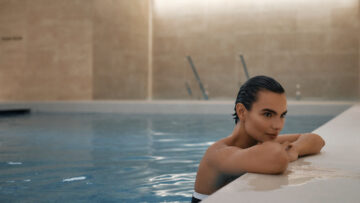 Woman leans on edge of pool at Orchard Place